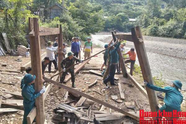 Lực lượng vũ trang xã Mường Típ (Nghệ An) hỗ trợ Nhân dân tháo dỡ nhà cửa di dời đến nơi ở mới